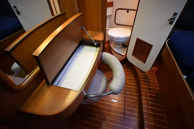Slide: The Image of Interior of 1989 Ta Shing Yachts Taswell 43, featuring wooden cabinetry and marine toilet. - 41