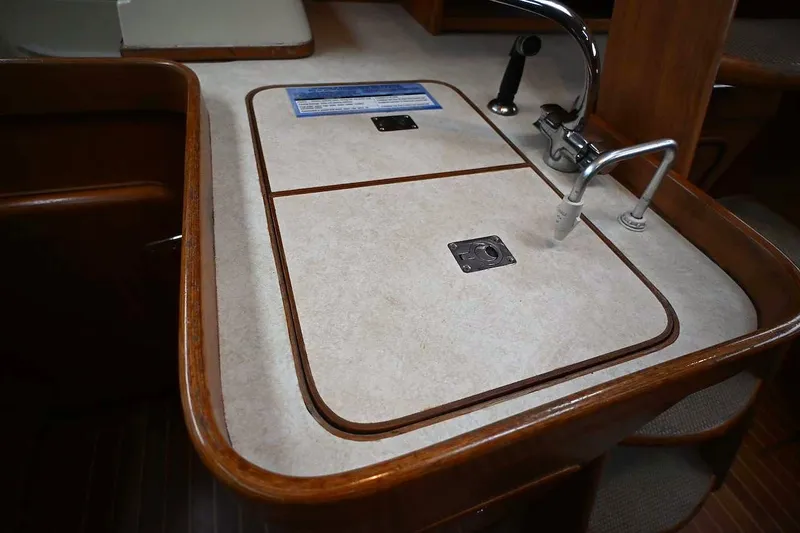 Slide: The Image of Galley sink area on 1989 Ta Shing Yachts Taswell 43, featuring wood trim and faucet. - 57