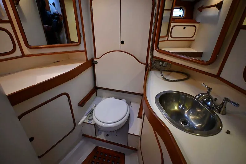 Slide: The Image of 1989 Ta Shing Yachts Taswell 43 bathroom with sink, toilet, and wooden accents. - 71