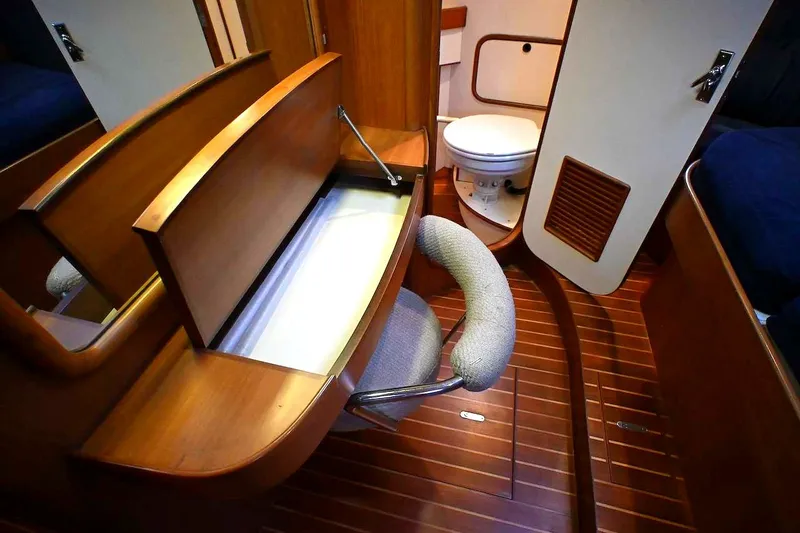 Slide: The Image of Interior of 1989 Ta Shing Yachts Taswell 43, featuring wooden cabinetry and marine toilet. - 47