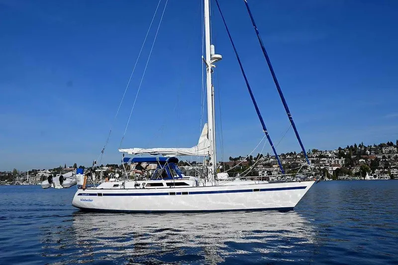 Slide: The Image of 1989 Ta Shing Yachts Taswell 43 sailboat on calm water, clear blue sky background. - 6
