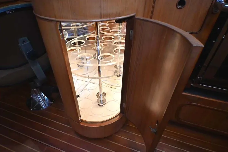 Slide: The Image of Open wooden cabinet with illuminated glass holder inside, aboard 1989 Ta Shing Yachts Taswell 43. - 54