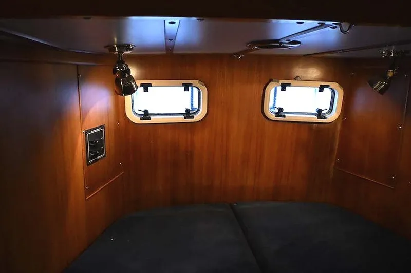 Slide: The Image of Cozy cabin interior of 1989 Ta Shing Yachts Taswell 43 with wooden paneling and portholes. - 40