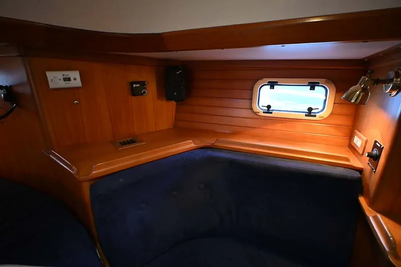 Slide: The Image of Cozy interior of 1989 Ta Shing Yachts Taswell 43 with wood paneling and porthole. - 39