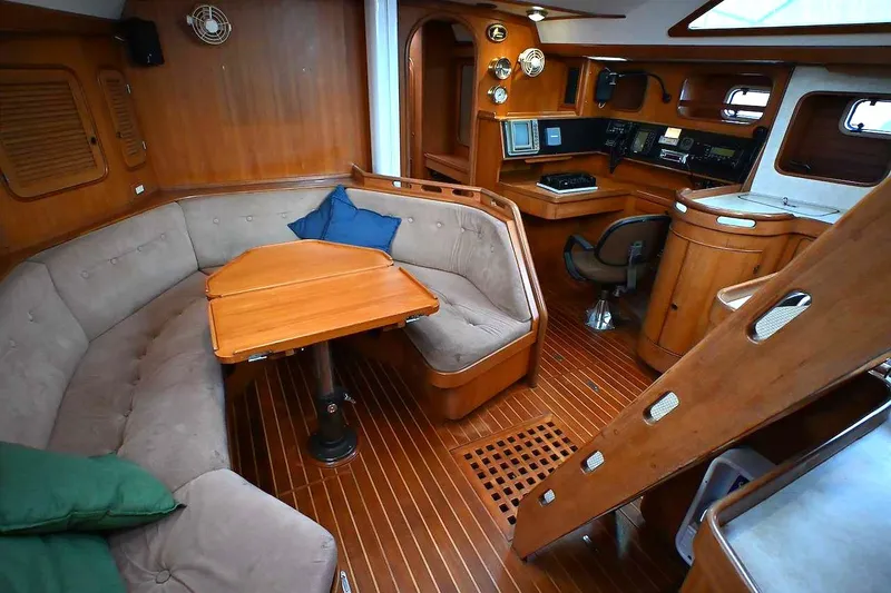 Slide: The Image of Luxurious 1989 Ta Shing Taswell 43 yacht interior with wood finish and cozy seating area. - 49