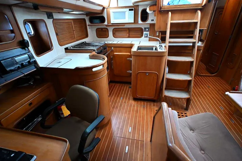 Slide: The Image of Interior of 1989 Ta Shing Yachts Taswell 43, featuring wooden cabinetry and nautical equipment. - 53