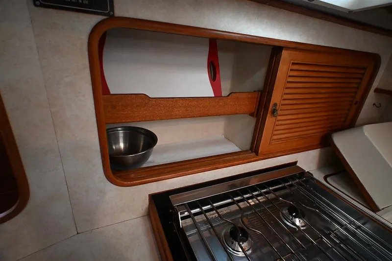 Slide: The Image of Interior of 1989 Ta Shing Taswell 43 yacht kitchen with stove and wooden cabinetry. - 60