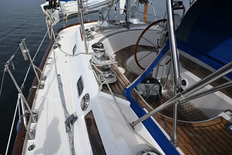 Slide: The Image of 1989 Ta Shing Yachts Taswell 43 sailboat deck with steering wheel and rigging. - 23