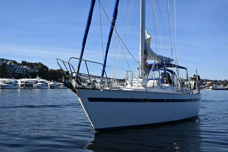 Slide: The Image of 1989 Ta Shing Yachts Taswell 43 sailboat on calm water, surrounded by other boats. - 7