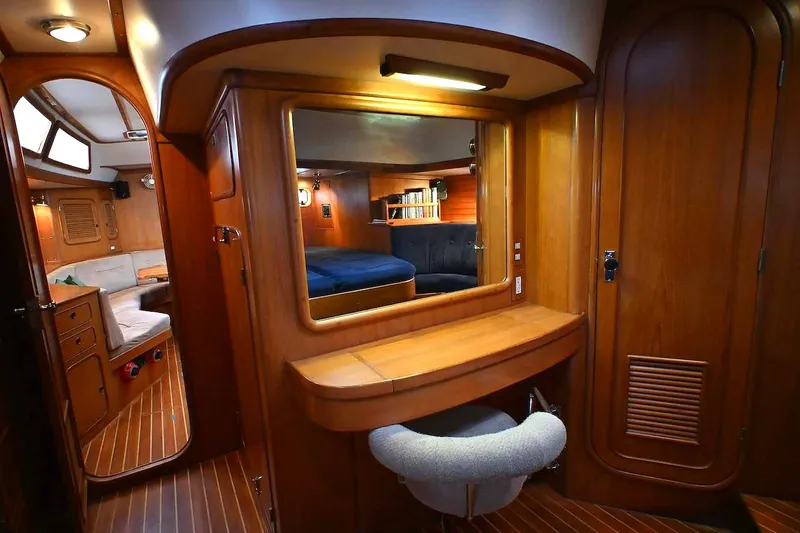 Slide: The Image of Luxurious 1989 Ta Shing Taswell 43 yacht interior with wooden cabinetry and cozy seating area. - 46