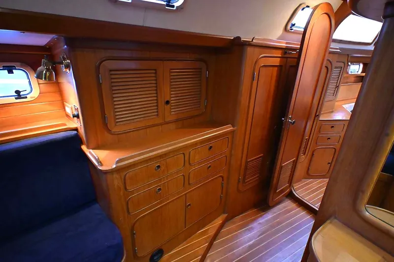 Slide: The Image of Interior of 1989 Ta Shing Yachts Taswell 43, featuring wooden cabinetry and seating. - 48