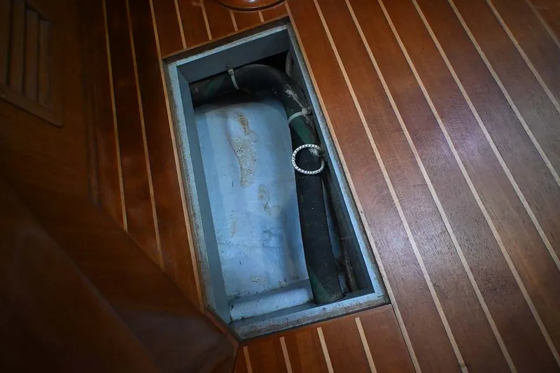 Slide: The Image of Wooden floor panel with an open hatch on a 1989 Ta Shing Yachts Taswell 43. - 86