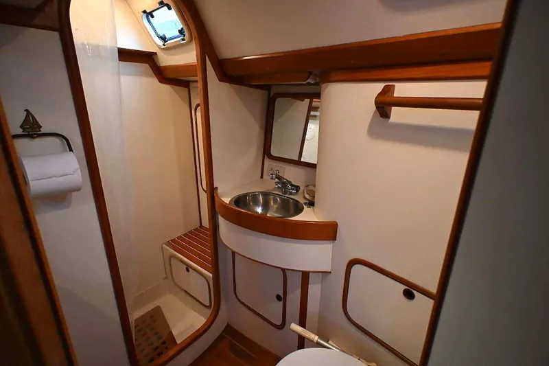 Slide: The Image of Interior of 1989 Ta Shing Yachts Taswell 43 bathroom with wooden accents and stainless steel sink. - 44