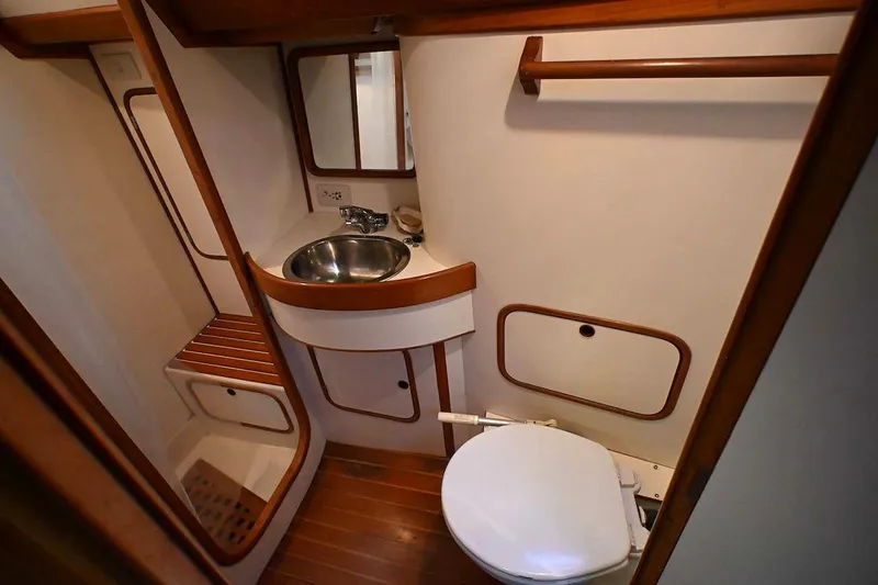Slide: The Image of 1989 Ta Shing Yachts Taswell 43 bathroom with sink, toilet, and wooden accents. - 45