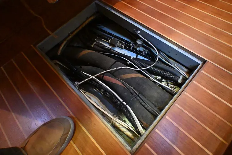 Slide: The Image of Open hatch on 1989 Ta Shing Yachts Taswell 43, revealing cables and hoses. - 85