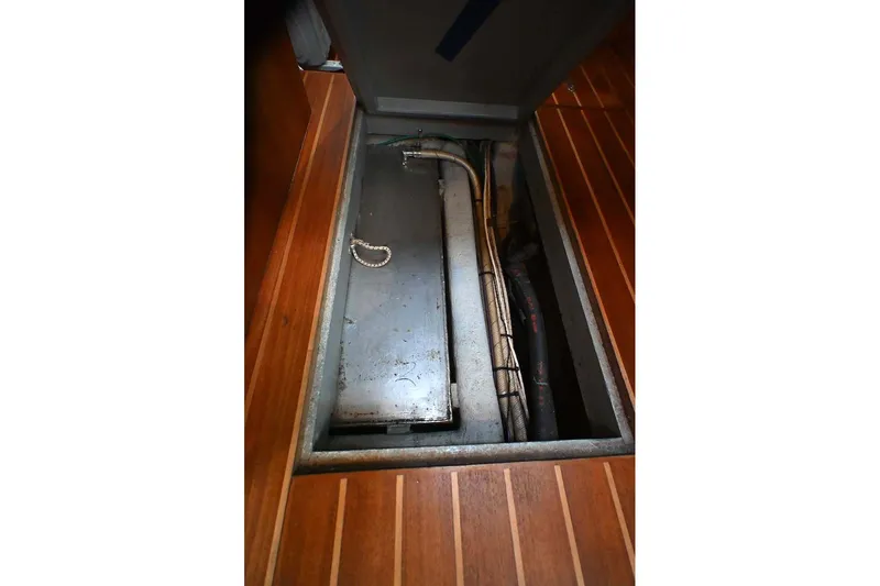 Slide: The Image of Storage compartment in 1989 Ta Shing Yachts Taswell 43, featuring wooden flooring and metal components. - 88