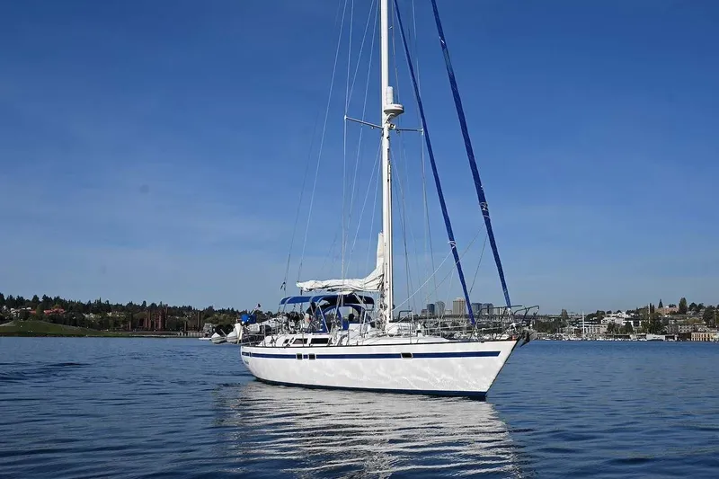 Slide: The Image of 1989 Ta Shing Yachts Taswell 43 sailboat on calm water under clear blue sky. - 5