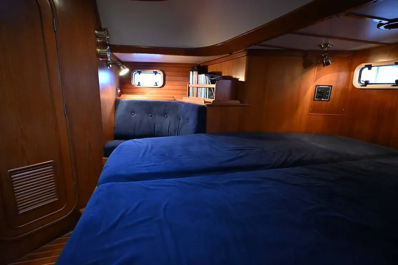 Slide: The Image of Cozy cabin interior of 1989 Ta Shing Yachts Taswell 43 with wood paneling and blue bedding. - 38