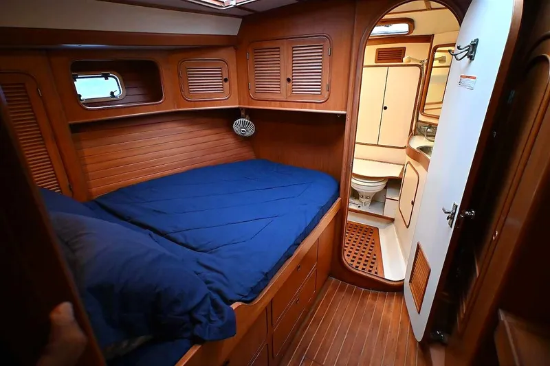Slide: The Image of Cozy cabin interior of 1989 Ta Shing Yachts Taswell 43 with wooden finish and blue bedding. - 62