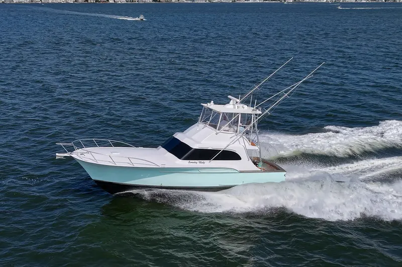 Slide: The Image of 1986 Buddy Davis 47 Convertible yacht cruising on open water. - 63