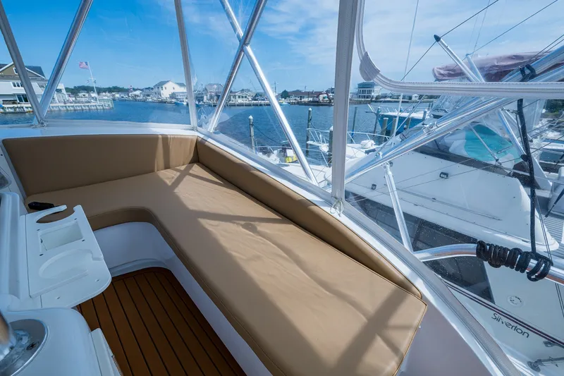 Slide: The Image of 1986 Buddy Davis 47 Convertible yacht interior with cushioned seating and marina view. - 31