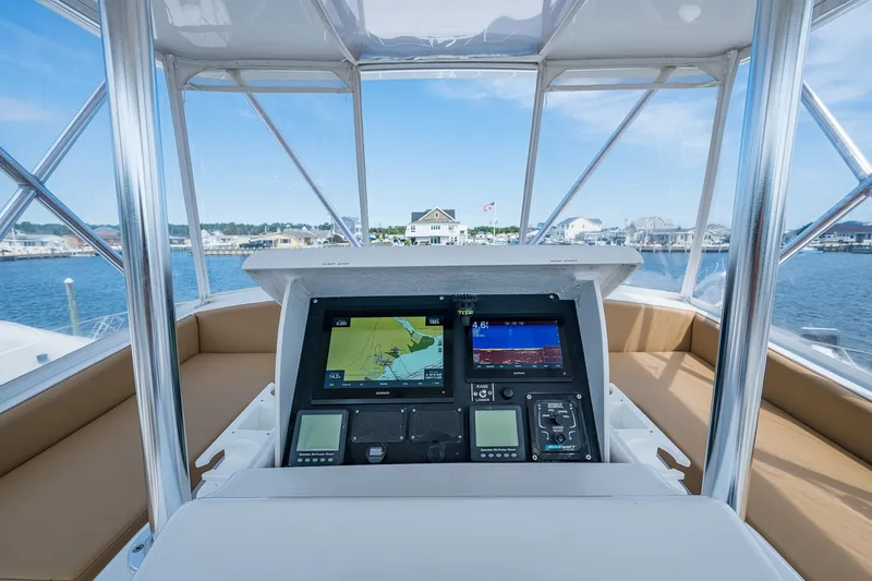 Slide: The Image of Helm of 1986 Buddy Davis 47 Convertible yacht with navigation screens, dockside view. - 26