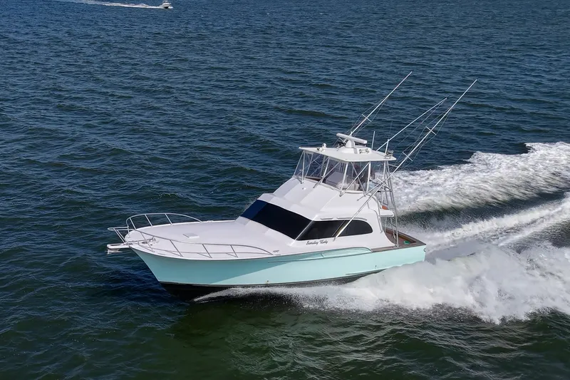 The Image of 1986 Buddy Davis 47 Convertible yacht cruising on open water. - 0