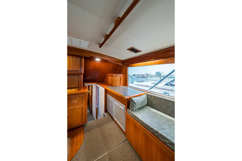Slide: The Image of Interior of 1986 Buddy Davis 47 Convertible yacht with wood cabinetry and seating area. - 76