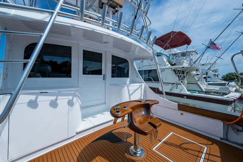 Slide: The Image of 1986 Buddy Davis 47 Convertible yacht deck with fishing chair and marina view. - 10