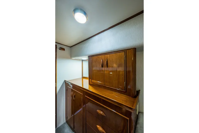 Slide: The Image of Interior of 1986 Buddy Davis 47 Convertible yacht with polished wooden cabinetry. - 42