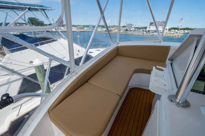 Slide: The Image of 1986 Buddy Davis 47 Convertible yacht interior with tan seating and marina view. - 30