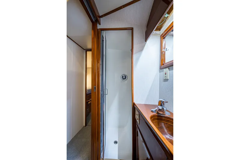 Slide: The Image of Bathroom interior of 1986 Buddy Davis 47 Convertible yacht, featuring shower and sink. - 39