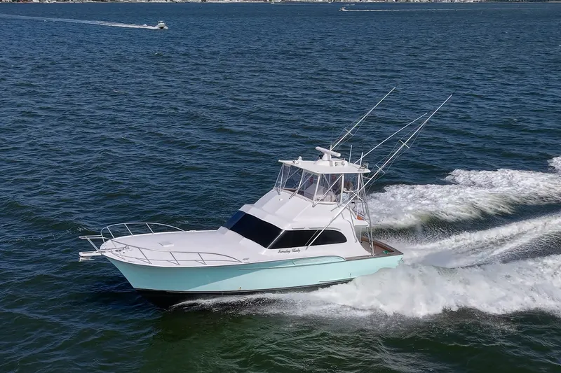 Slide: The Image of 1986 Buddy Davis 47 Convertible yacht cruising on open water, showcasing sleek design and performance. - 3