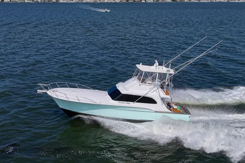 Slide: The Image of 1986 Buddy Davis 47 Convertible yacht cruising on open water. - 62
