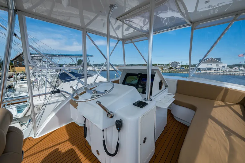 Slide: The Image of Helm of 1986 Buddy Davis 47 Convertible yacht with modern controls and panoramic marina view. - 23