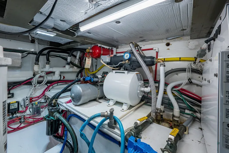 Slide: The Image of Engine room of 1986 Buddy Davis 47 Convertible with complex wiring and machinery. - 19