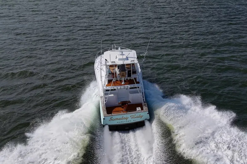 Slide: The Image of 1986 Buddy Davis 47 Convertible yacht cruising on open water, rear view. - 65