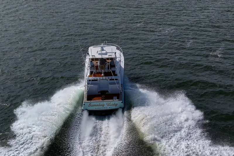 Slide: The Image of 1986 Buddy Davis 47 Convertible yacht cruising on open water, rear view. - 67