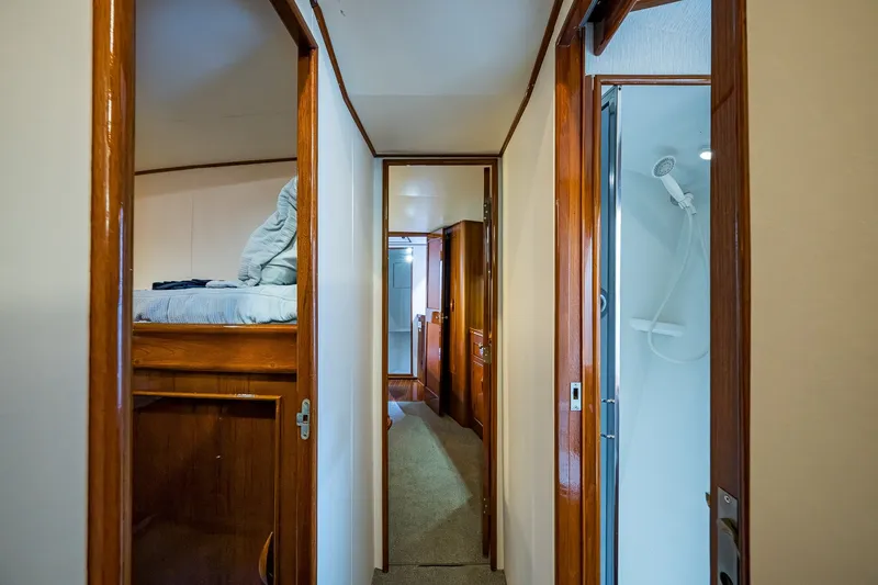 Slide: The Image of Interior hallway of 1986 Buddy Davis 47 Convertible yacht, featuring wood finishes and a shower. - 44