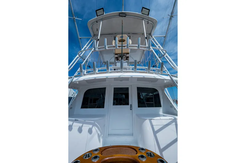 Slide: The Image of 1986 Buddy Davis 47 Convertible yacht, showcasing sleek design and sturdy structure under a clear sky. - 8