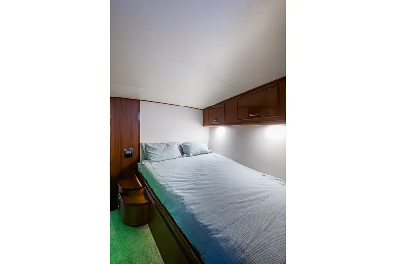 Slide: The Image of Cozy cabin interior of 1986 Buddy Davis 47 Convertible yacht with bed and wooden cabinets. - 36