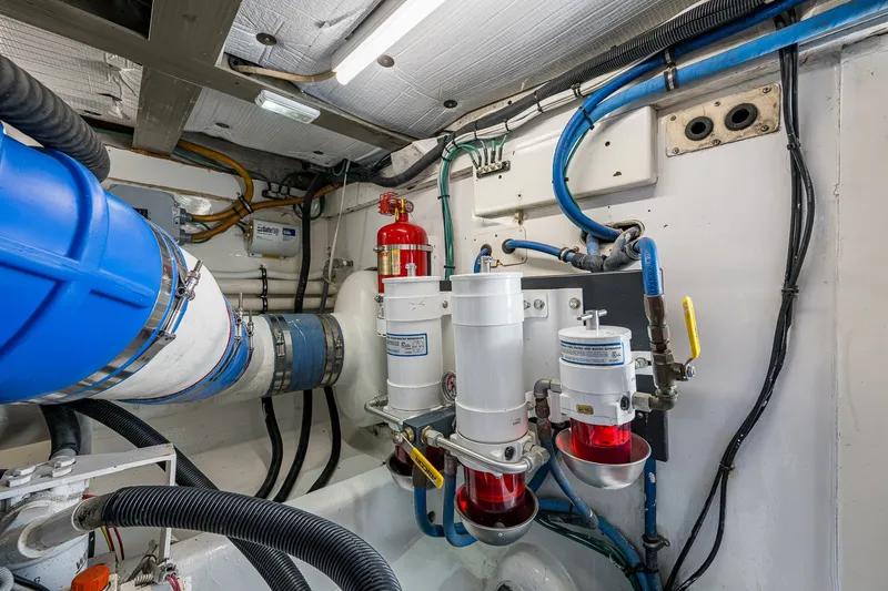 Slide: The Image of Engine room of 1986 Buddy Davis 47 Convertible with visible piping and fire extinguisher. - 21