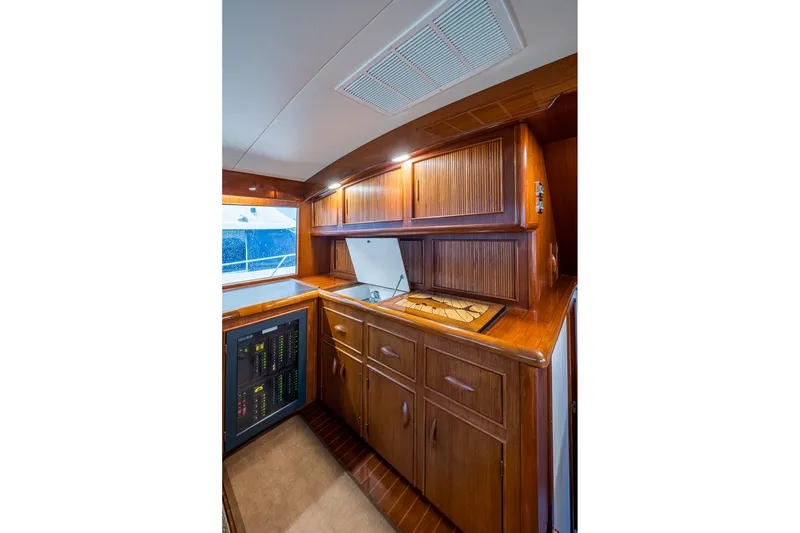 Slide: The Image of Interior of 1986 Buddy Davis 47 Convertible yacht with wooden cabinetry and modern amenities. - 73