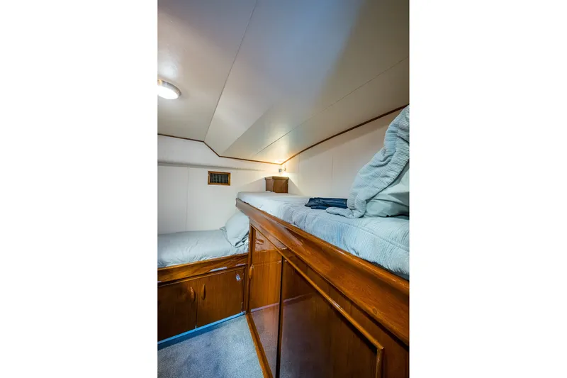 Slide: The Image of Cozy cabin interior of 1986 Buddy Davis 47 Convertible yacht with wooden bunk beds. - 41