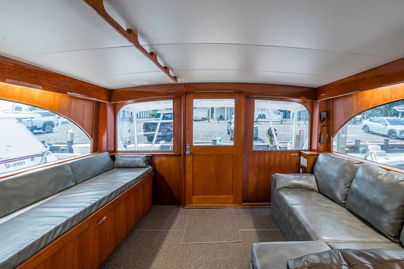 Slide: The Image of Interior of 1986 Buddy Davis 47 Convertible yacht with leather seating and wooden finishes. - 79
