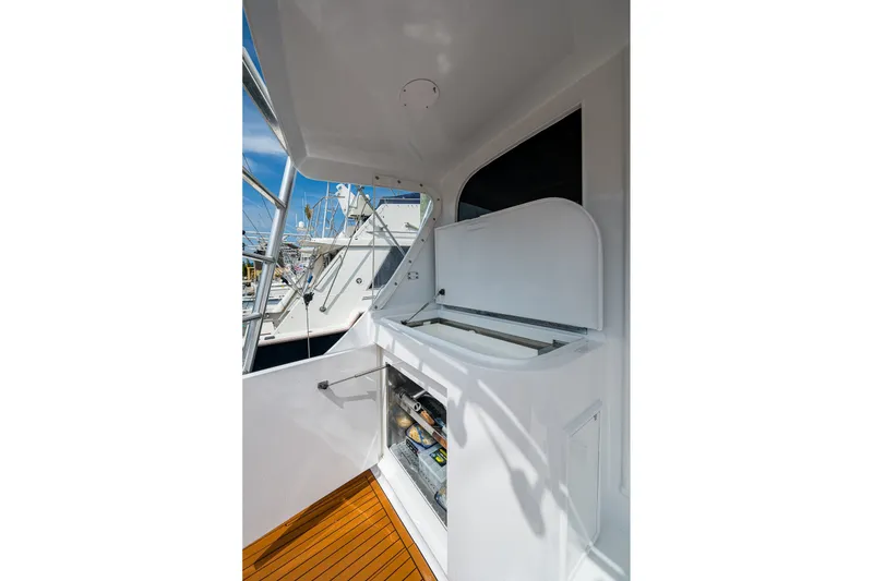 Slide: The Image of 1986 Buddy Davis 47 Convertible yacht with open storage compartment on deck. - 12