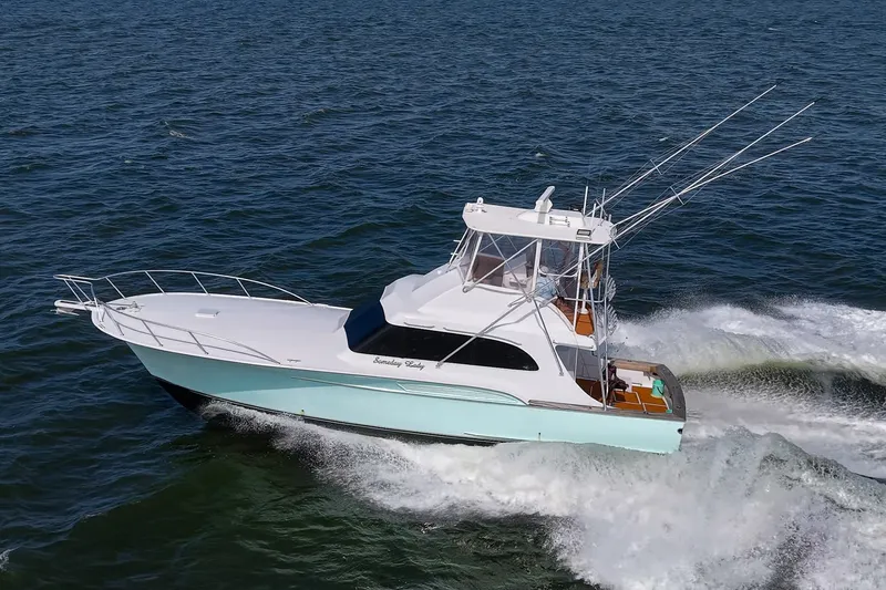 Slide: The Image of 1986 Buddy Davis 47 Convertible yacht cruising on open water. - 61