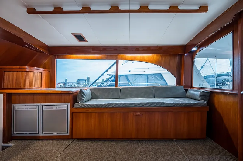 Slide: The Image of Interior of 1986 Buddy Davis 47 Convertible yacht with wood paneling and cushioned seating. - 77