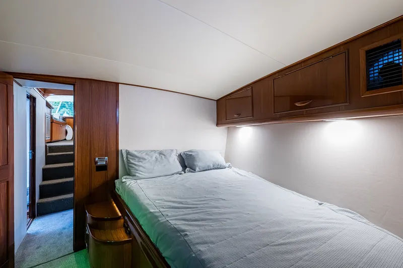 Slide: The Image of Interior cabin of 1986 Buddy Davis 47 Convertible yacht with cozy bed and wooden cabinetry. - 35