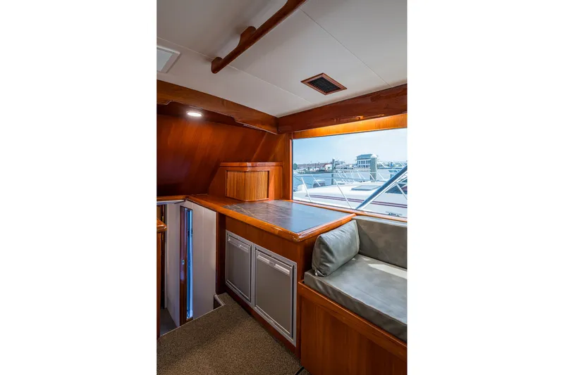 Slide: The Image of Interior of 1986 Buddy Davis 47 Convertible yacht with wood finish and window view. - 74
